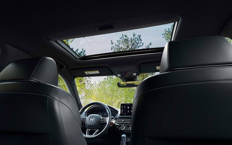 2027 Honda Civic Hatchback Sport Touring Hybrid interior detail of the power moonroof and overhead console (Compact Hatchback). 2027 Honda Civic Hatchback Sport Touring Hybrid interior detail of the power moonroof and overhead console (Compact Hatchback).