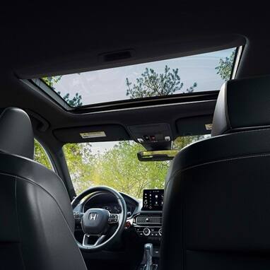 2027 Honda Civic Hatchback Sport Touring Hybrid interior detail of the power moonroof and overhead console (Compact Hatchback).